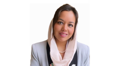 Nour Mansouri wears light colored suit