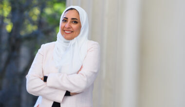 Amira stands by columns at MIT with arms crossed